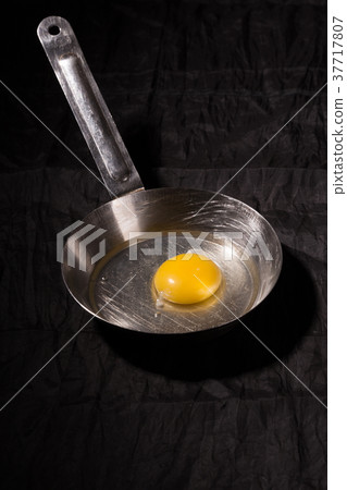 Raw egg in a metal griddle Raw egg in a metal griddle 37717807