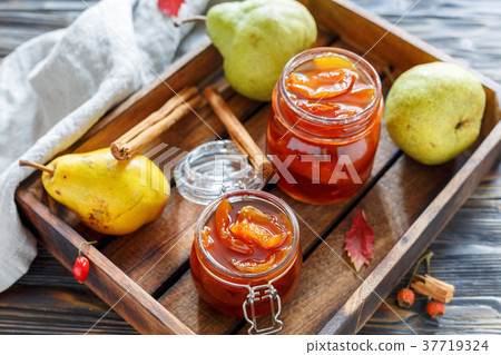 Jam from pears in glass jars and fresh pear. Jam from pears in glass jars and fresh pear. 37719324