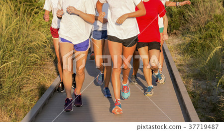 High School girls running on a boardwalk High School girls running on a boardwalk 37719487