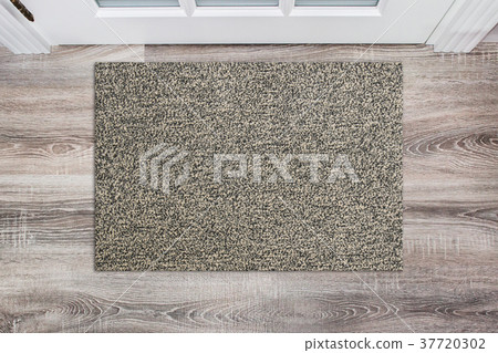 Blank beige woolen doormat before the white door 37720302