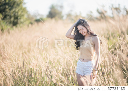 Portrait Asia girl in the sunset on the field Portrait Asia girl in the sunset on the field 37725485