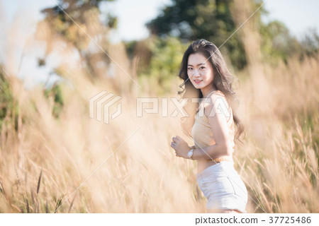Portrait Asia girl in the sunset on the field Portrait Asia girl in the sunset on the field 37725486