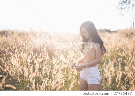 Portrait Asia girl in the sunset on the field Portrait Asia girl in the sunset on the field 37725487