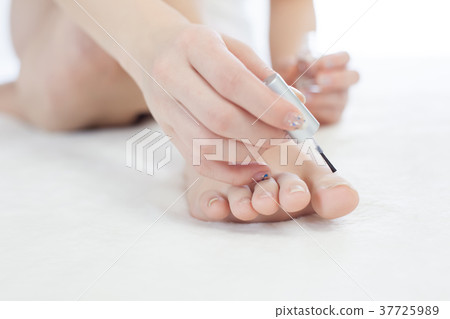 A woman painting a pedicure A woman painting a pedicure 37725989