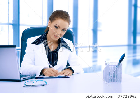 Attractive businesswoman working with laptop 37728962