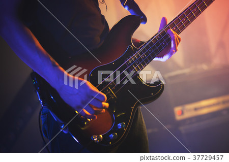 Electric bass guitar player, close up photo Electric bass guitar player, close up photo 37729457