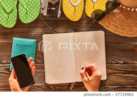 Woman planning a beach trip 37729962