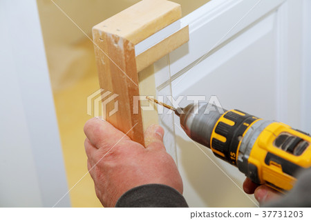 master drills the cabinet door in the cabinet door 37731203
