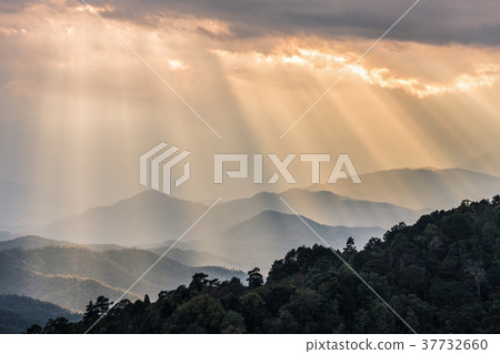 Sunbeam shining through cloudy sky to mountains Sunbeam shining through cloudy sky to mountains 37732660
