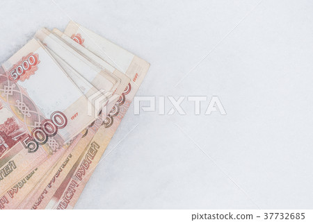 Five thousand russian roubles banknotes on snow 37732685