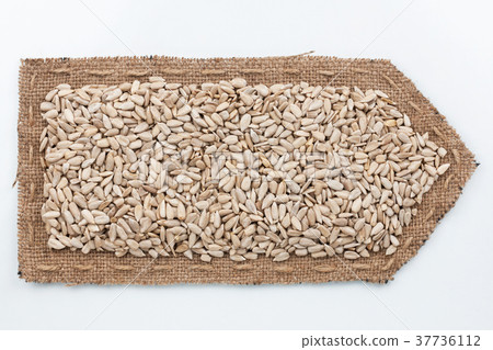 Arrow made of burlap with sunflower seeds. Arrow made of burlap with sunflower seeds. 37736112