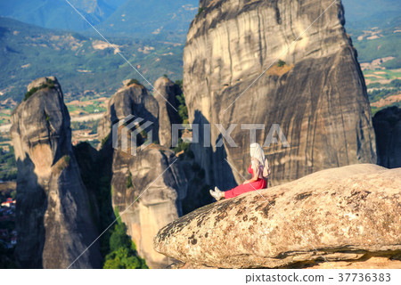 Alone girl on a top of the rock of Meteora,Greece 37736383
