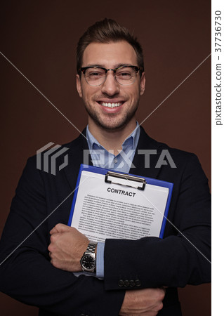 Cheerful businessman holding documents in arms 37736730