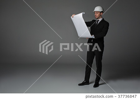 Serious worker watching at plan 37736847
