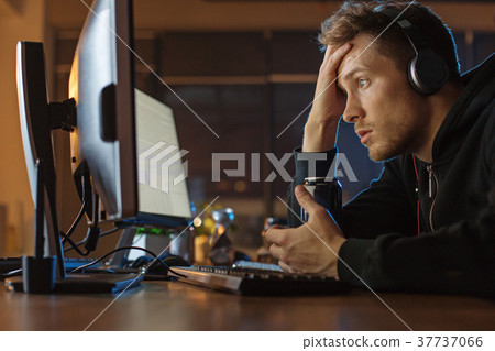 Amazed male watching at screen of appliance Amazed male watching at screen of appliance 37737066