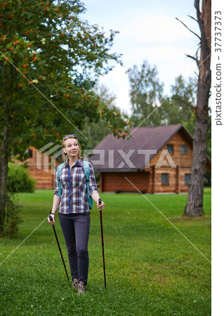 young woman with nordic walk pols young woman with nordic walk pols 37737373