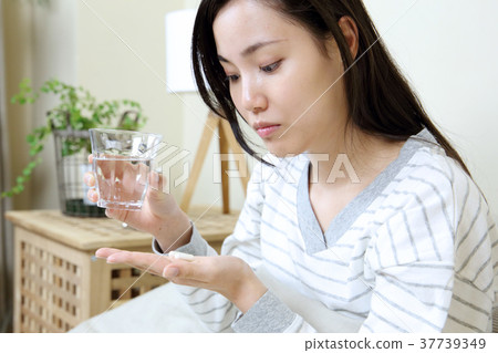 Woman taking medicine 37739349