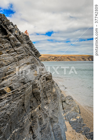 Man sitting on the edge of the cliff 37742809