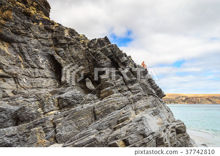 Man sitting on the edge of the cliff at Rapid Bay, 37742810