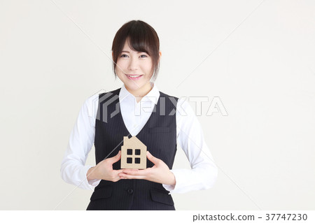 A woman with a housing model A woman with a housing model 37747230