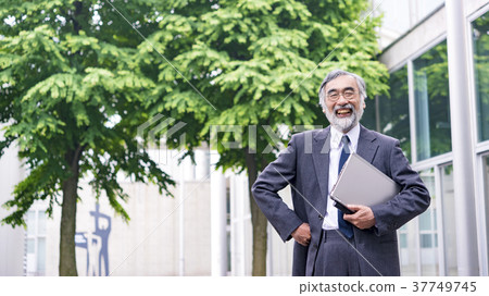 University professor standing in front of the school building University professor standing in front of the school building 37749745