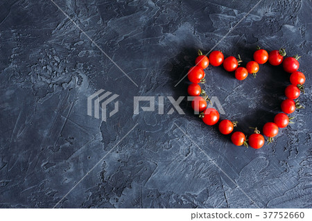 Tomatoes lie in the form of heart with copy space 37752660
