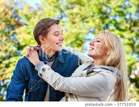 Spring couple walking park. Summer friends walk Spring couple walking park. Summer friends walk 37752859