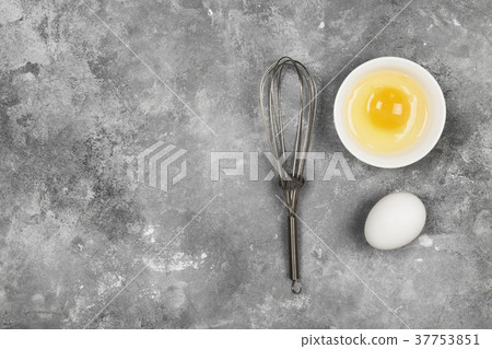 Eggs and whisk for whipping on a gray background Eggs and whisk for whipping on a gray background 37753851