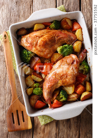 Delicious baked rabbit legs with potatoes 37755592