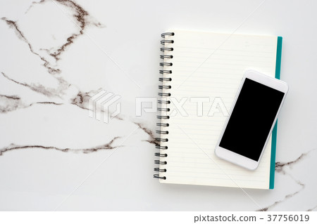 Blank smart phone on notebook background 37756019