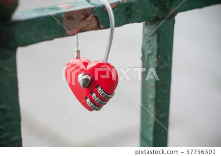red padlock in shaped heart on metallic grid red padlock in shaped heart on metallic grid 37756301