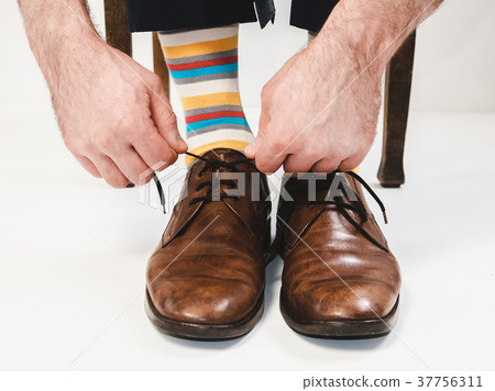 Men's feet in stylish shoes and bright socks Men's feet in stylish shoes and bright socks 37756311