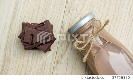 Chocolate milk on a wooden table. Chocolate milk on a wooden table. 37756550