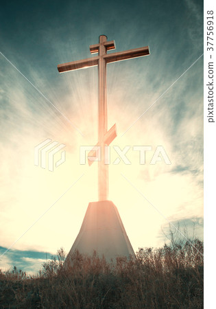 Dramatic filtered Christian cross with sun rays 37756918