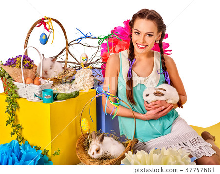 Woman in easter style holding rabbit and flowers 37757681