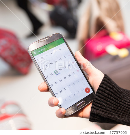 Woman checking calendar information on mobile 37757903