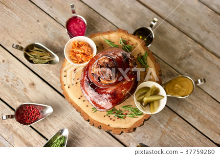 Pork knuckle with many different side dishes. 37759280