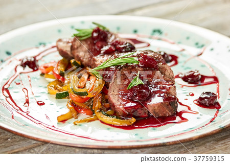 Veal with grilled vegetables and sauce. Veal with grilled vegetables and sauce. 37759315
