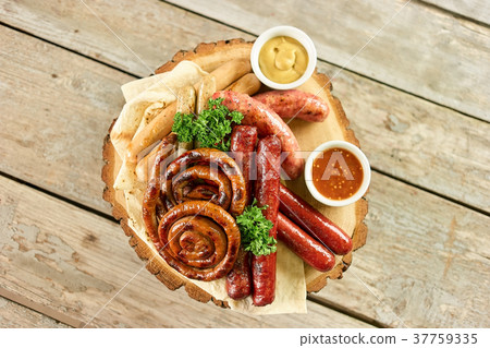 Top view of sausage assortment dish. 37759335