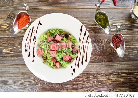 Green salad with beef, cornichons and mustard. Green salad with beef, cornichons and mustard. 37759408