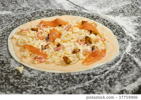Seafood ingredients on pizza dough basis. Seafood ingredients on pizza dough basis. 37759906