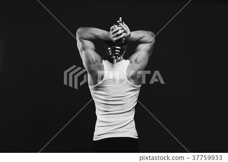 Strong athletic man with dumbbell showes muscular 37759933