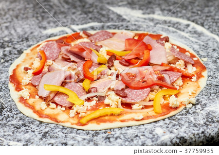 Pizza with sausages, sliced pepper and tomatoes. Pizza with sausages, sliced pepper and tomatoes. 37759935