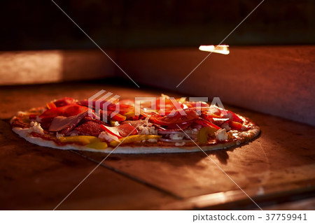 Process of baking pizza inside pizza oven. Process of baking pizza inside pizza oven. 37759941