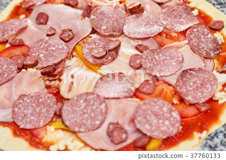 Sliced sausages on pizza close up. Sliced sausages on pizza close up. 37760133