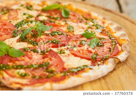 Close up tomato pizza with basil. Close up tomato pizza with basil. 37760378