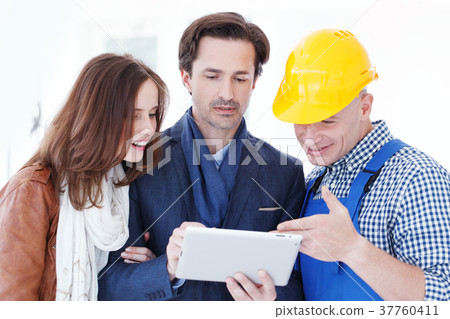 Worker and couple using tablet pc 37760411