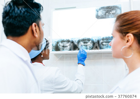 Multiracial dental team checking teeth x ray of Multiracial dental team checking teeth x ray of 37760874