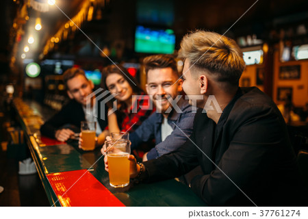 Happy football fans raised their glasses with beer 37761274