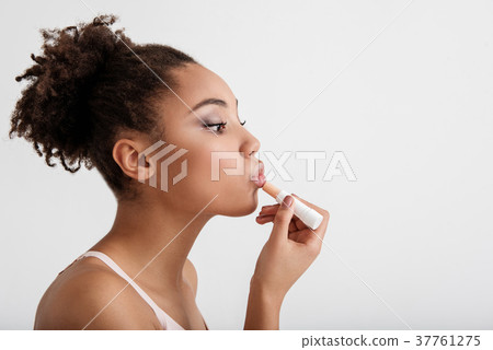 Calm girl using daily cosmetics Calm girl using daily cosmetics 37761275